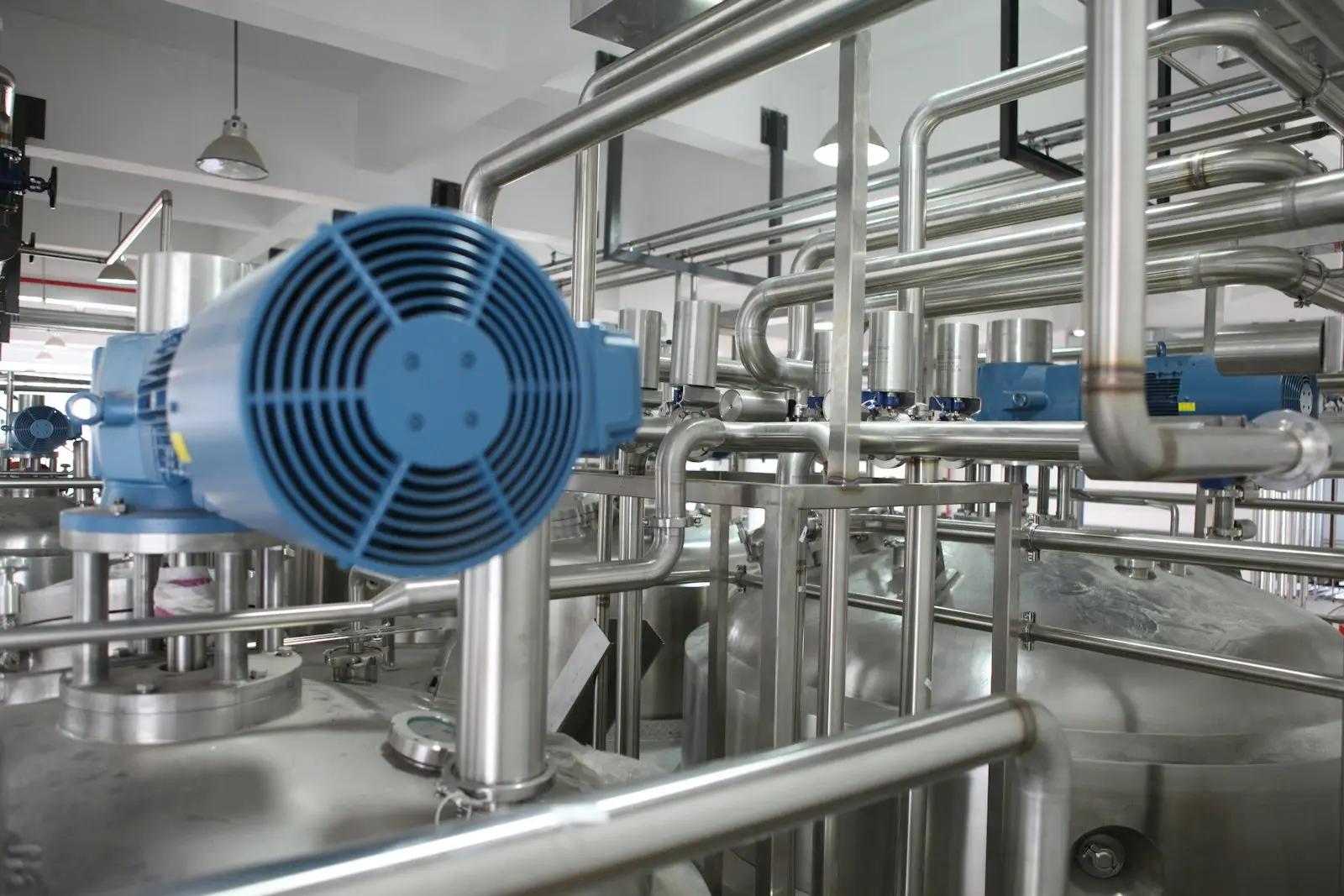 Industrial plant room with fans and pipework