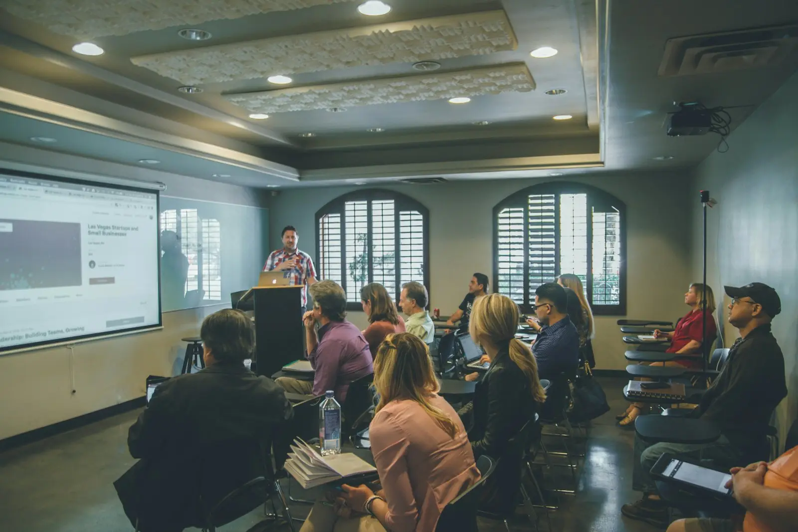 Facilitator leading a training session in a seminar room